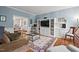 Comfortable living room with blue walls, built-in shelving, and a decorative rug at 800 Oxbow Crossing Rd, Chapel Hill, NC 27516