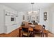 Spacious dining area with hardwood floors and built-in shelving, leading to the living area at 800 Oxbow Crossing Rd, Chapel Hill, NC 27516
