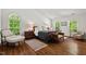 Bright bedroom with large arched windows, hardwood floors, and comfortable seating at 800 Oxbow Crossing Rd, Chapel Hill, NC 27516