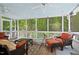 Relaxing screened porch with wooded views, comfortable seating, and overhead fans at 800 Oxbow Crossing Rd, Chapel Hill, NC 27516