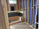 Unfinished bathroom showcasing the new shower area, revealing the waterproofing stage at 803 Fireship Rd, Fuquay Varina, NC 27526