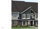 Exterior view of home with dark brick and siding, complemented by a well-maintained lawn and flowerbeds at 803 Fireship Rd, Fuquay Varina, NC 27526