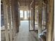 Unfinished hallway view showing stairs and door, in the construction stage at 803 Fireship Rd, Fuquay Varina, NC 27526