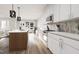 Modern kitchen featuring white cabinets, stainless steel appliances, and a stylish island with wood accents at 803 Fireship Rd, Fuquay Varina, NC 27526