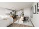 Open-concept living space with a dining area and modern kitchen featuring a central island with seating at 803 Fireship Rd, Fuquay Varina, NC 27526