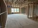 Exposed wood framing in an unfinished living room of a new home with three windows at 803 Fireship Rd, Fuquay Varina, NC 27526