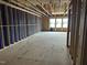 Unfinished living room with exposed framing and construction materials at 803 Fireship Rd, Fuquay Varina, NC 27526