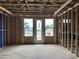 Unfinished room showing the framing and construction stage, with view of a door leading outside at 803 Fireship Rd, Fuquay Varina, NC 27526
