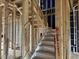 Interior framing of a staircase showing construction with wood and blue insulation at 803 Fireship Rd, Fuquay Varina, NC 27526