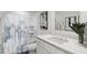 Well-lit bathroom with a shower-tub combination, white cabinets, and modern fixtures for comfort and style at 805 Fireship Rd, Fuquay Varina, NC 27526