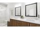 Beautiful bathroom features double sinks, wood cabinetry, and bright lights, for a luxurious experience at 805 Fireship Rd, Fuquay Varina, NC 27526