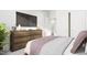 Contemporary bedroom featuring a dresser and a large TV for modern comfort and entertainment at 805 Fireship Rd, Fuquay Varina, NC 27526
