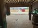 Unfinished garage featuring an open door with a view of the neighborhood and construction site at 805 Fireship Rd, Fuquay Varina, NC 27526