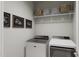 Modern laundry room featuring front load washer/dryer and practical shelving at 805 Fireship Rd, Fuquay Varina, NC 27526