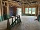 Bright, unfinished living room featuring a large window and door to the outside at 805 Fireship Rd, Fuquay Varina, NC 27526