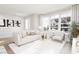 Bright living room with modern furnishings, large windows, and hardwood flooring, creating an inviting space at 805 Fireship Rd, Fuquay Varina, NC 27526