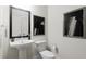 Stylish powder room with pedestal sink, decorative mirror, and modern accents at 805 Fireship Rd, Fuquay Varina, NC 27526