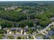 Aerial view of a home and community with mature trees and lake access at 817 Highwater Pl, Fuquay Varina, NC 27526