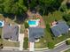 Aerial view of a gray home with a pool, a large backyard, and a beautifully landscaped yard at 817 Highwater Pl, Fuquay Varina, NC 27526
