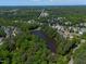 Scenic aerial view of neighborhood and lake with lush green trees in surrounding area at 817 Highwater Pl, Fuquay Varina, NC 27526