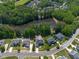 Beautiful aerial view of a neighborhood with a lake, lush trees and homes with manicured lawns at 817 Highwater Pl, Fuquay Varina, NC 27526