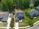Beautiful aerial view of a brick home with a pool on a large lot with lush trees and a pond at 817 Highwater Pl, Fuquay Varina, NC 27526