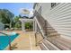 Backyard view with a pool, seating area, and stairs to an elevated deck for outdoor enjoyment at 817 Highwater Pl, Fuquay Varina, NC 27526