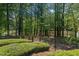 Gated backyard with mature trees and lake access providing privacy and nature at 817 Highwater Pl, Fuquay Varina, NC 27526