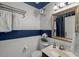 Stylish bathroom featuring blue and white walls, mirror, and sink, offering a fresh design at 817 Highwater Pl, Fuquay Varina, NC 27526