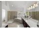 Bright bathroom features a separate shower, soaking tub, and vanity with dual sinks at 817 Highwater Pl, Fuquay Varina, NC 27526