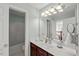Bright bathroom with white vanity, bathtub, and views of the staircase through a mirror at 817 Highwater Pl, Fuquay Varina, NC 27526