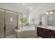 Bright bathroom features a separate shower, soaking tub, and vanity with dual sinks at 817 Highwater Pl, Fuquay Varina, NC 27526