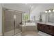 Bright bathroom features a separate shower, soaking tub, and vanity with dual sinks at 817 Highwater Pl, Fuquay Varina, NC 27526