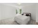 Simple bedroom with neutral walls and two windows, offering a calm, minimalist aesthetic at 817 Highwater Pl, Fuquay Varina, NC 27526