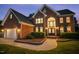 Charming brick home with an attached two-car garage, complemented by manicured landscaping and a paved walkway at 817 Highwater Pl, Fuquay Varina, NC 27526