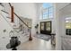 Grand foyer boasts a high ceiling, chandelier, staircase, and double doors at 817 Highwater Pl, Fuquay Varina, NC 27526