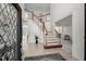 Grand foyer with a staircase, tile flooring, and a view into other rooms, creating an inviting entrance at 817 Highwater Pl, Fuquay Varina, NC 27526