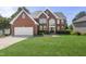 Two-story brick home with a manicured lawn, attached garage, and a grand entrance at 817 Highwater Pl, Fuquay Varina, NC 27526