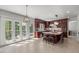 Bright open kitchen with island, stainless steel appliances, and French doors leading to the outdoor area at 817 Highwater Pl, Fuquay Varina, NC 27526