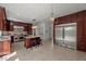 Spacious kitchen with dark wood cabinetry, a large island, stainless steel appliances and tile flooring at 817 Highwater Pl, Fuquay Varina, NC 27526