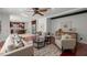 Open-concept living room with hardwood floors, comfortable seating, and seamless connection to kitchen area at 817 Highwater Pl, Fuquay Varina, NC 27526