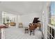 Bright living room with large window, baby grand piano, and ample seating at 817 Highwater Pl, Fuquay Varina, NC 27526