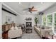 Well-lit living room with neutral-toned furniture, a ceiling fan, fireplace and a large area rug at 817 Highwater Pl, Fuquay Varina, NC 27526