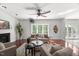 Bright living room with large windows, comfortable sofas, hardwood flooring, and an inviting atmosphere at 817 Highwater Pl, Fuquay Varina, NC 27526