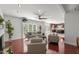 Bright and airy living room featuring hardwood floors, neutral furniture, and an open layout to the kitchen at 817 Highwater Pl, Fuquay Varina, NC 27526