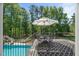 Outdoor space with a seating area near a pool and slide in a tree-filled backyard at 817 Highwater Pl, Fuquay Varina, NC 27526