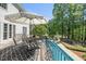 Relaxing deck with shade by the poolside, complete with table and umbrella at 817 Highwater Pl, Fuquay Varina, NC 27526