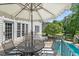 Outdoor area with a stylish umbrella and seating next to a pool slide in a lush backyard at 817 Highwater Pl, Fuquay Varina, NC 27526