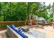 Back deck features a comfortable outdoor seating area and charming playhouse at 8600 Clivedon Dr, Raleigh, NC 27615