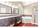 Bathroom features dual vanities, a soaking tub, and a tiled accent wall at 8600 Clivedon Dr, Raleigh, NC 27615